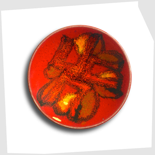 Poole Pottery pin dish, shape 49, by Rosina St Clayre, finished in a rich red glaze with fluid forms of orange and green