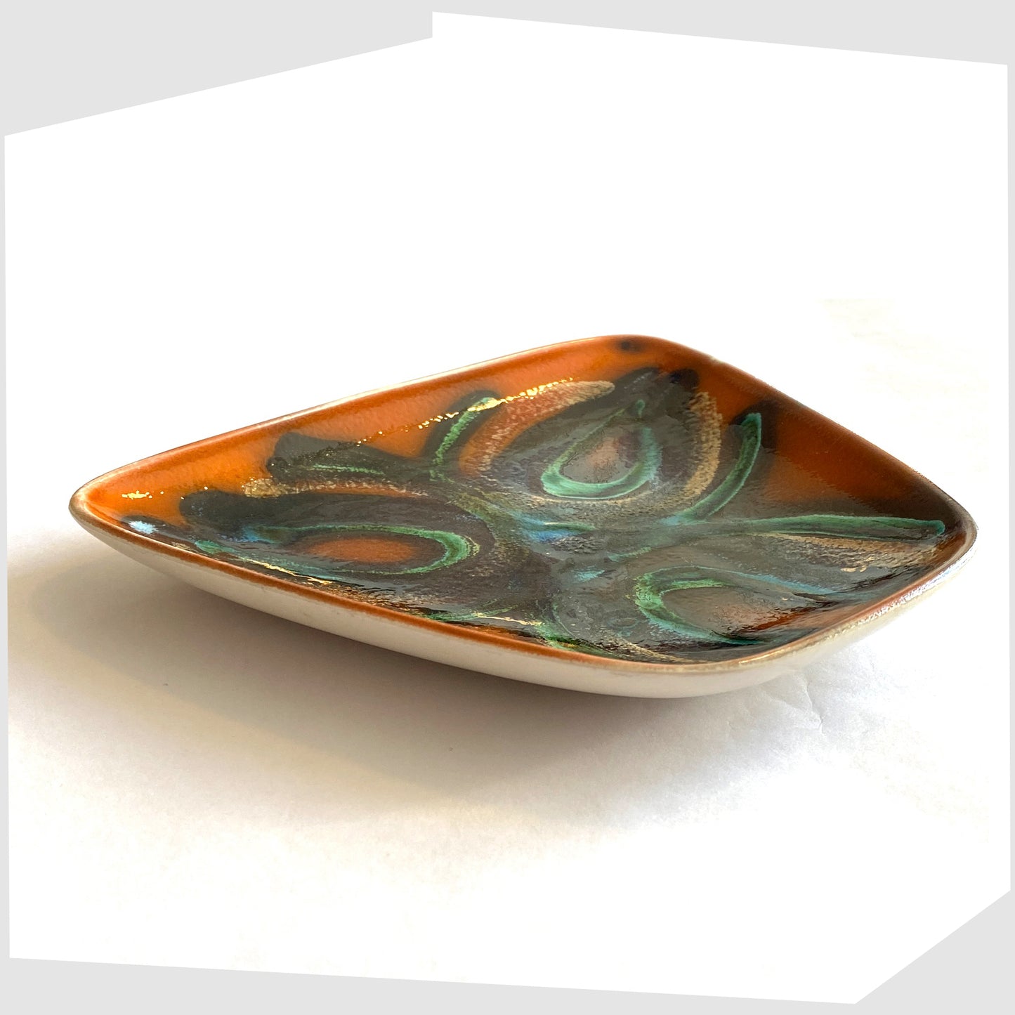 side profile of the Poole Pottery Dish, Shape 81, by Particia Wells finished in a vibrant orange with artistic lines of black and green glaze
