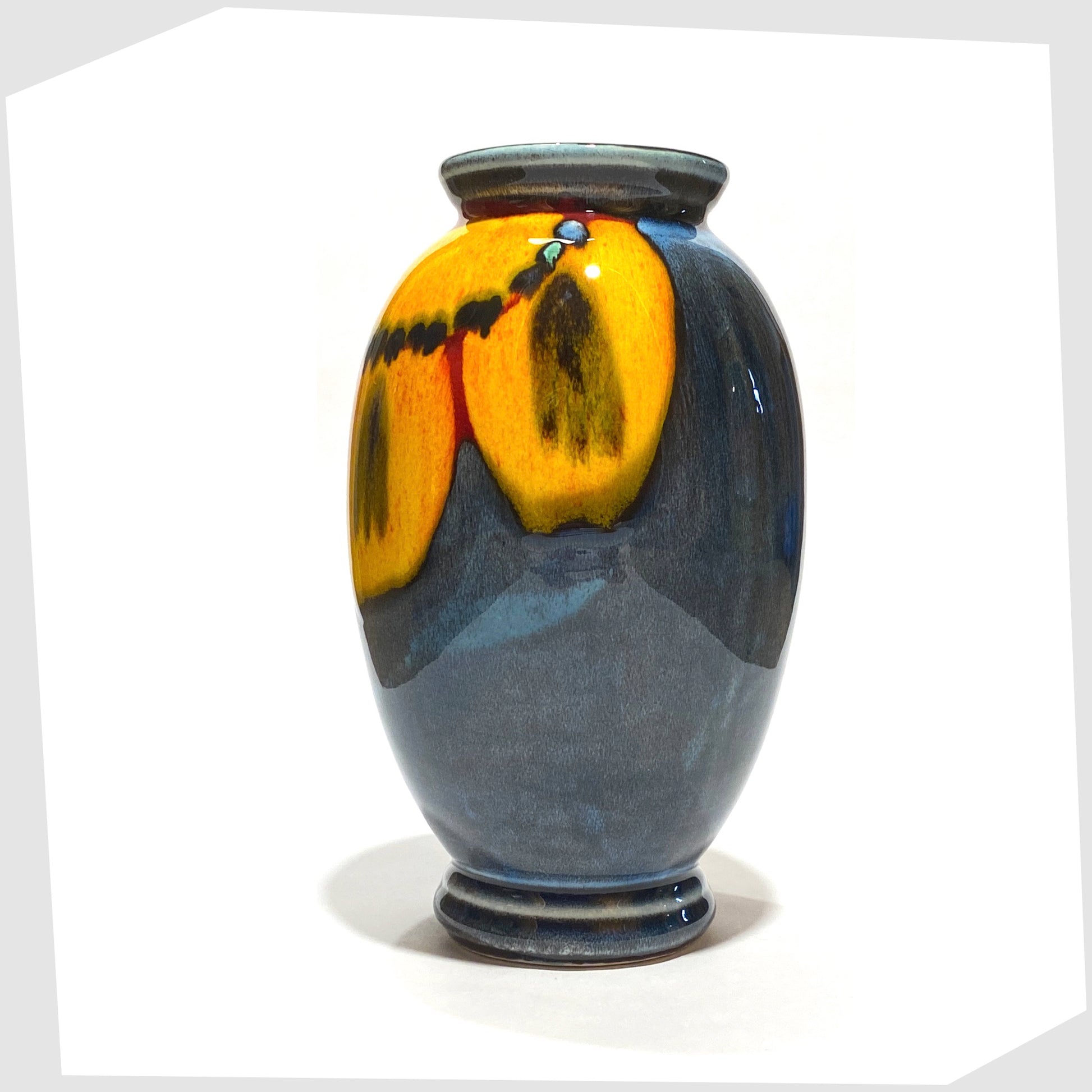 poole pottery wild poppy vase designed by anita harris, featuring a vivid yellow flower on a blue glaze