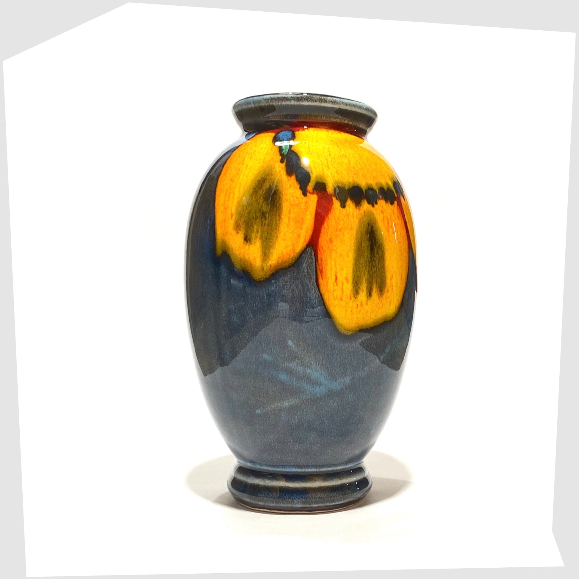 poole pottery wild poppy vase designed by anita harris, glazed in a vivid yellow flower on a marbled blue background