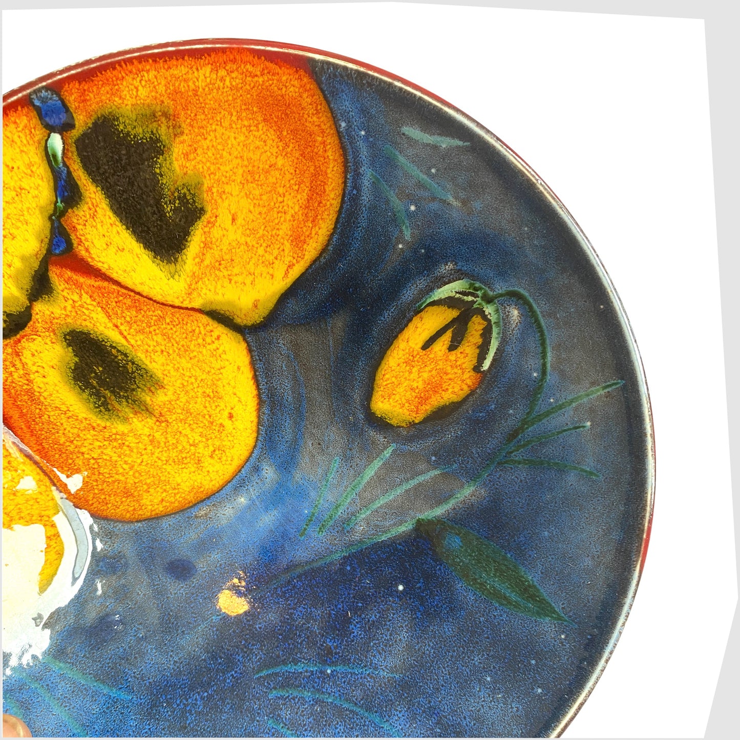 close up of the vintage Poole Pottery Wild Poppy Dish, designed by Anita Harris, glazed in vivid blue with yellow poppy petals
