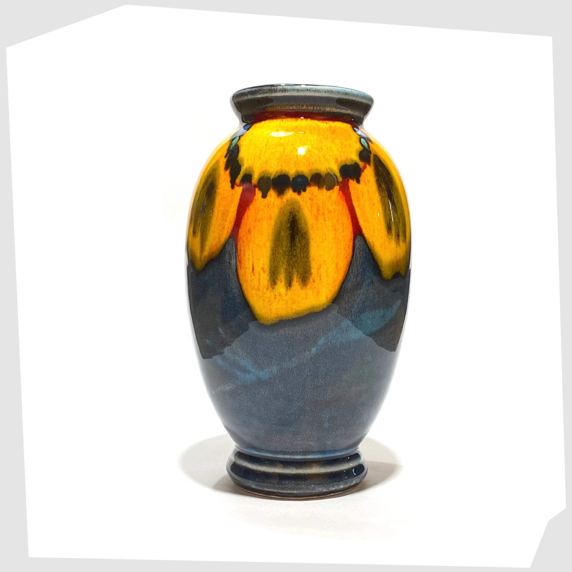 poole pottery wild poppy vase designed by anita harris, glazed with a yellow flower on a marbled blue background