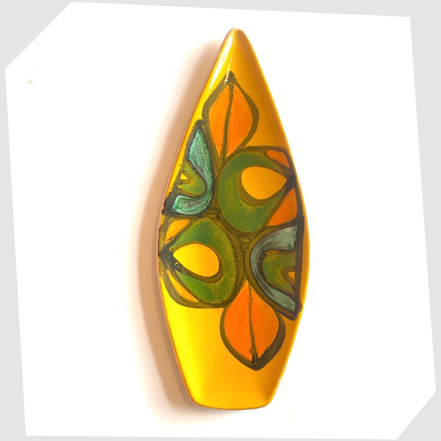 1970s poole pottery delphis spear dish, shape 82, by Rosina St Clayre finished in a vibrant yellow glaze with free-forms of green, orange and turquoise