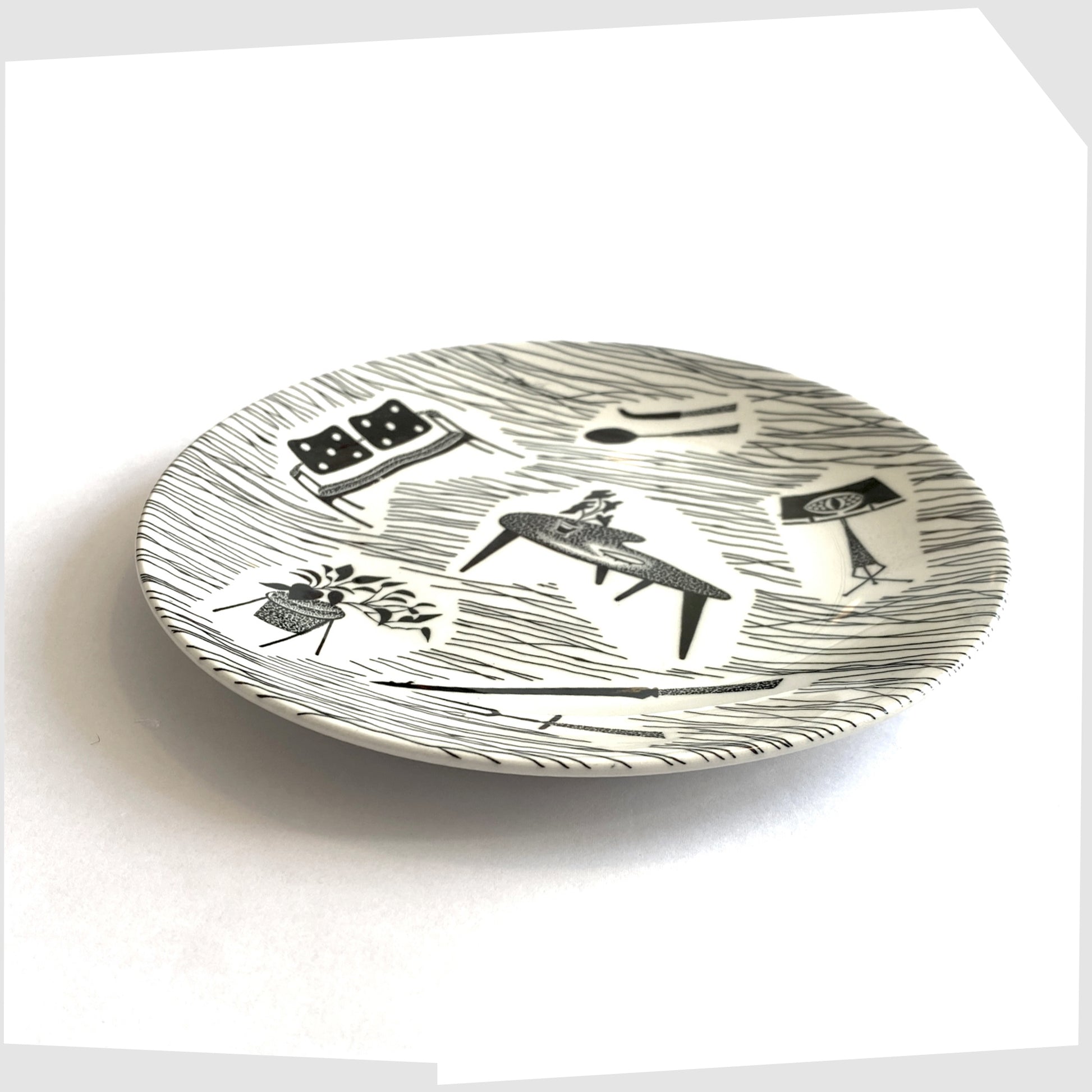 homemaker ceramic side plate with iconic black and white print of chairs, tables, lamps etc