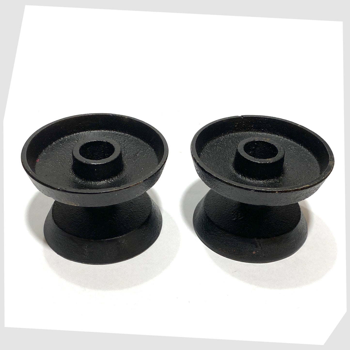 pair of robert welsh inspired candleholder made of black cast iron 