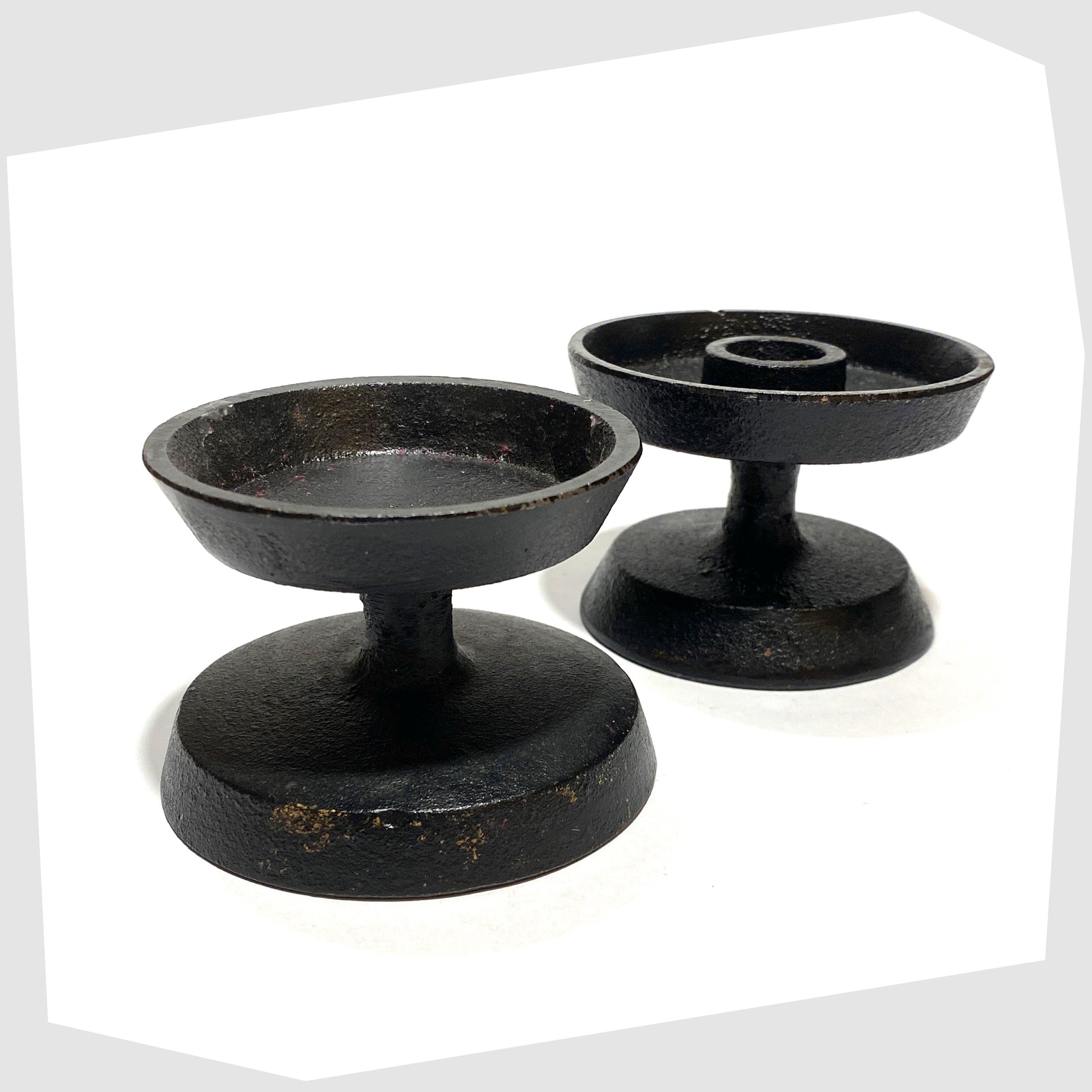 pair of robert welsh inspired reversible candleholder made of black cast iron