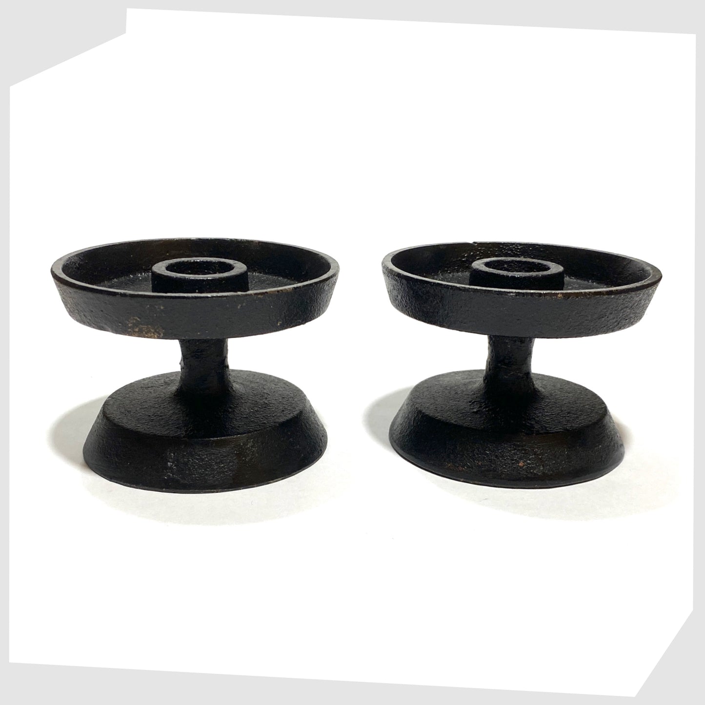 pair of vintage robert welsh inspired candleholder made of black cast iron