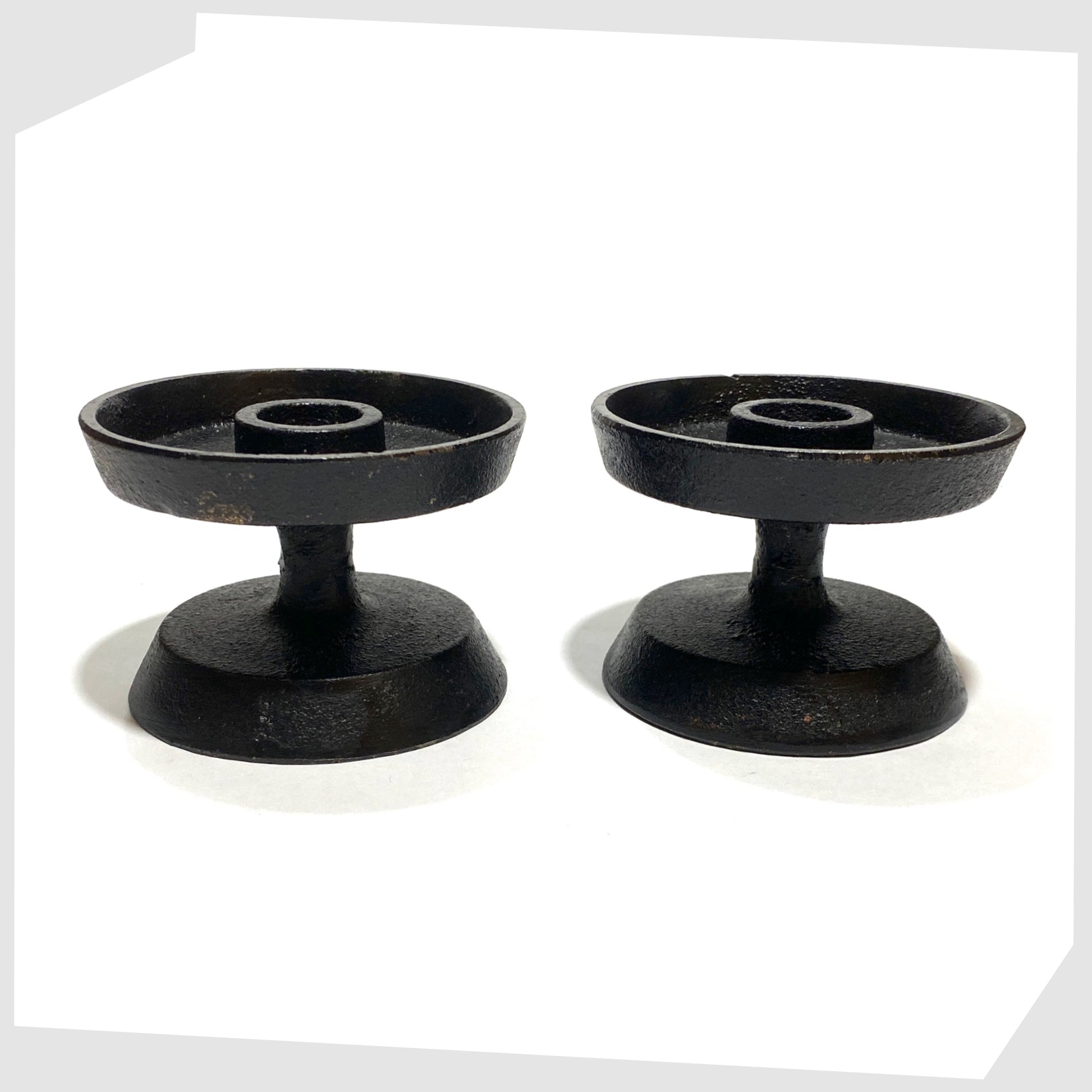 pair of vintage robert welsh inspired candleholder made of black cast iron