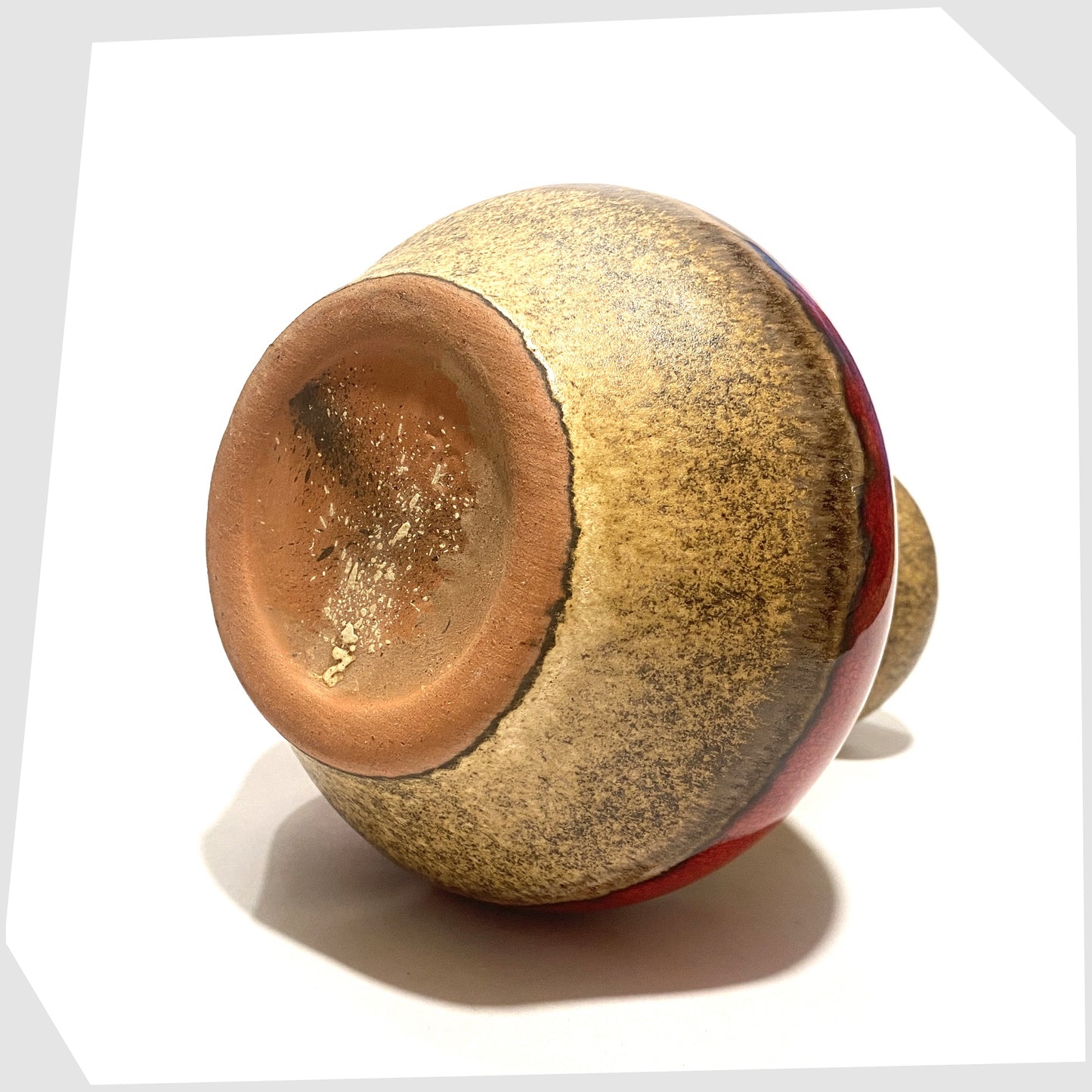base of the roth keramik vase with curved handle with a central stripe of volcanic red glaze