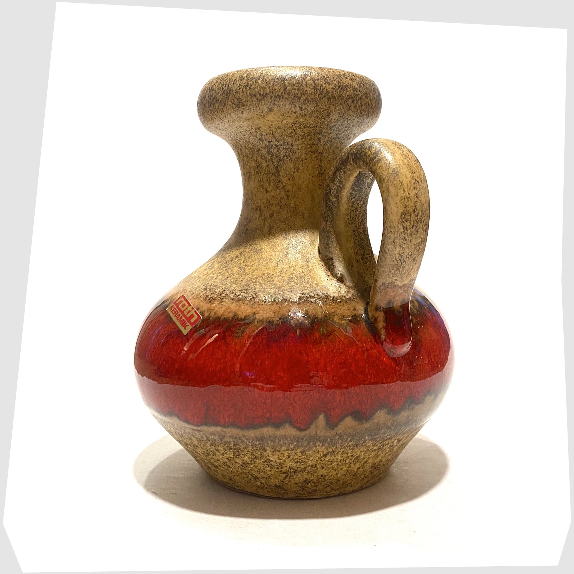 roth keramik vase with curved handle with a central stripe of volcanic red glaze. Complete with its original label attached