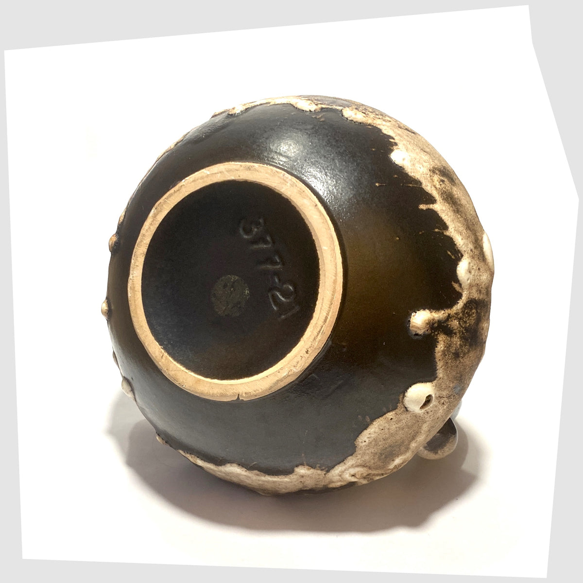 Base of the of the Ruscha Keramik 377-21 Vase in monochrome fat lava drip glaze, shown on a white background