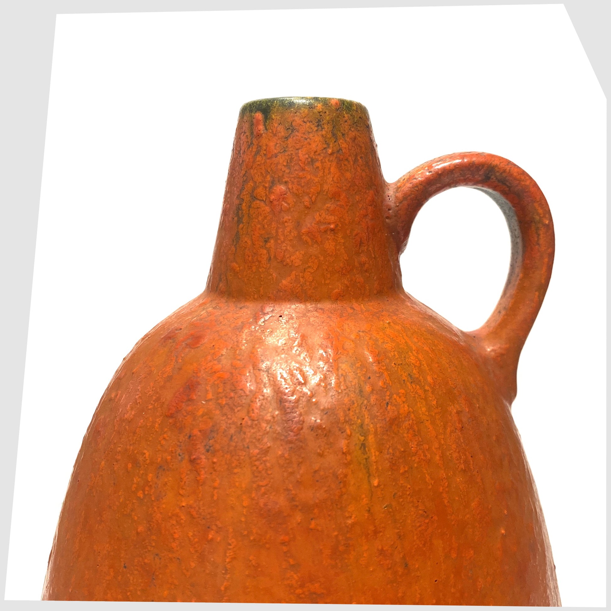 Close up of the looped handle of the Ruscha Keramik Vase in matte volcanic orange glaze, shown on a white background