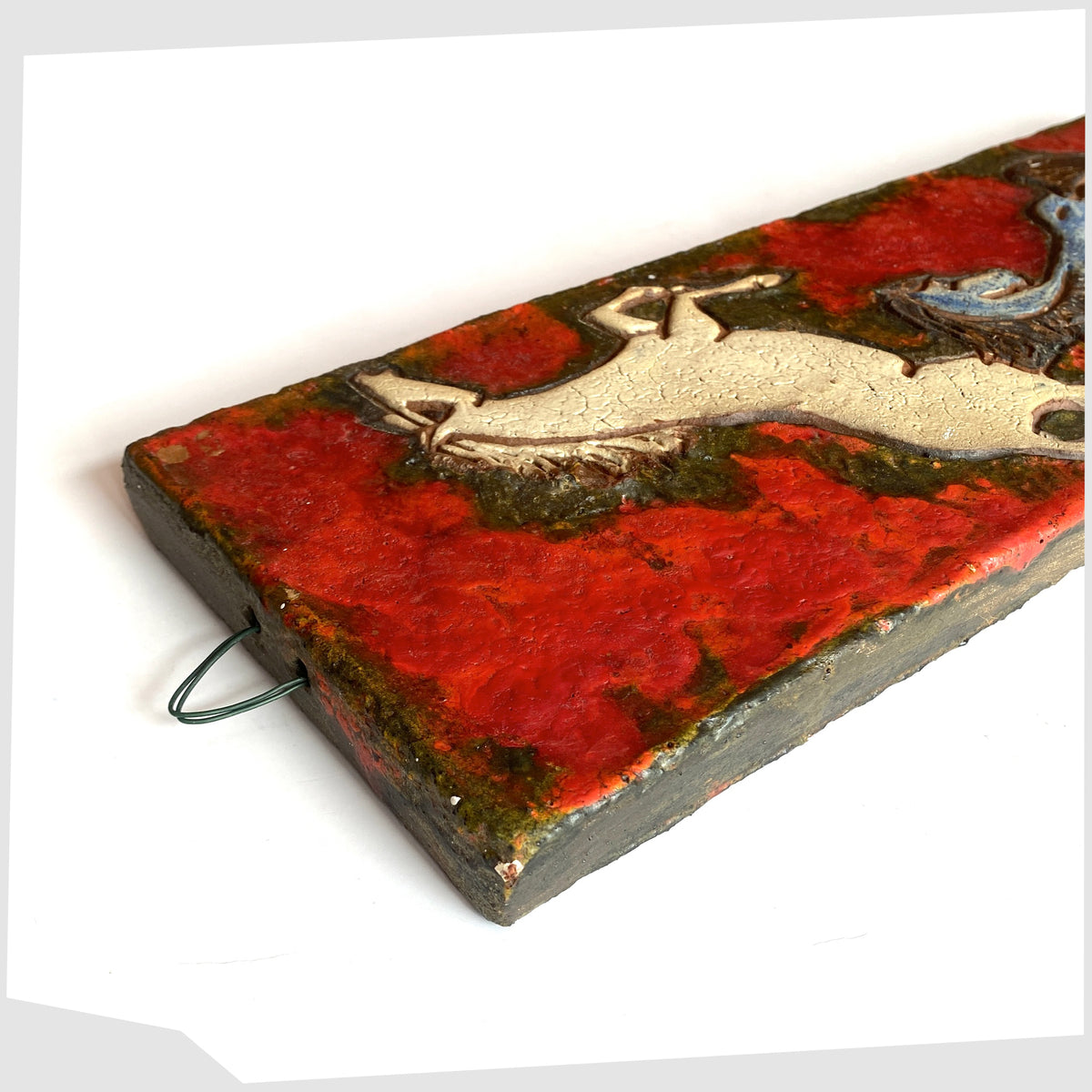 Top hanging loop of the Ruscha Keramik Wall Plaque, designed by Adele Bolz, featuring a pair of horses on a red fat lava glaze, shown on a white background
