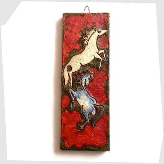 Ruscha Keramik Wall Plaque, designed by Adele Bolz, featuring a pair of horses on a red fat lava glaze, shown on a white background