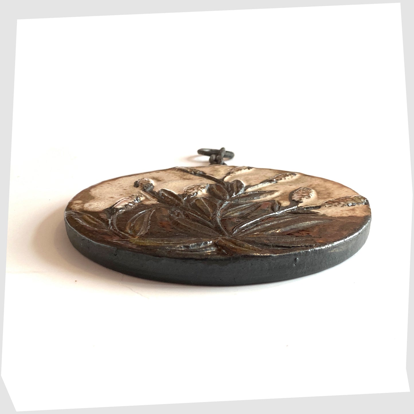 side profile of the Ruscha Keramik Wall Plaque made in 1970s West Germany, with original chain mount