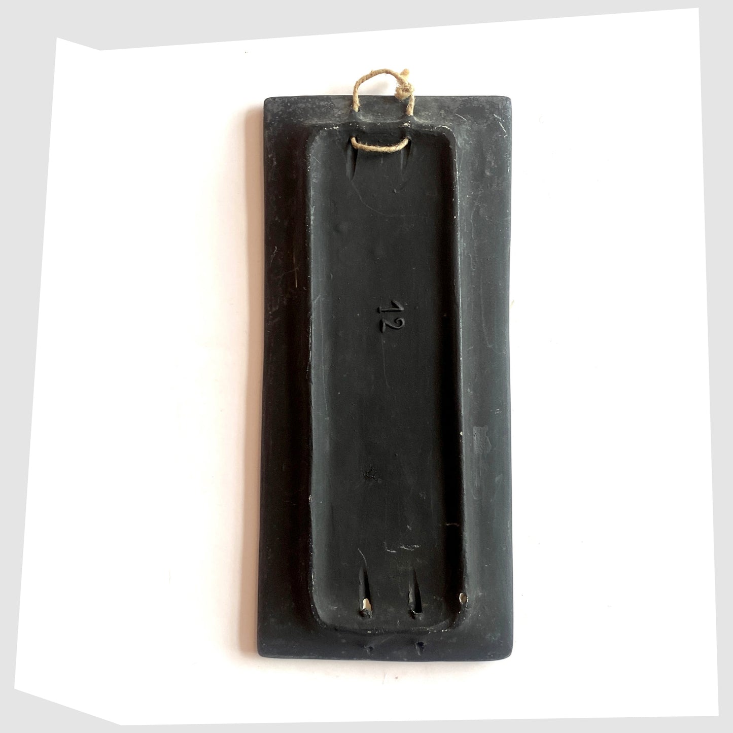 Rear of the San Marino Pottery Wall Plaque with impressed model number and string hanging loop, shown on a white background