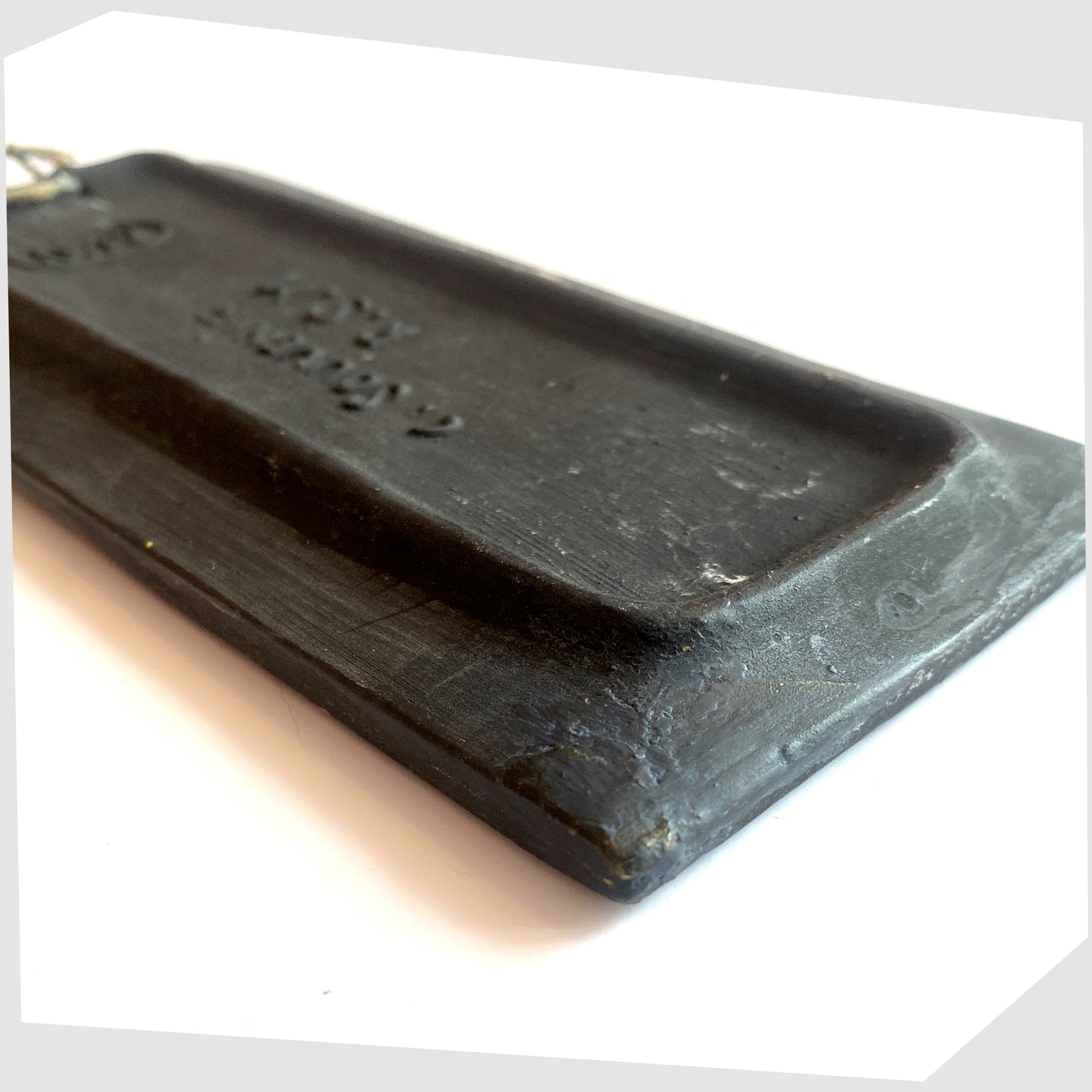 Close up of the rear of the rectangular San Marino Pottery Wall Plaque with impressed model number, shown on a white background