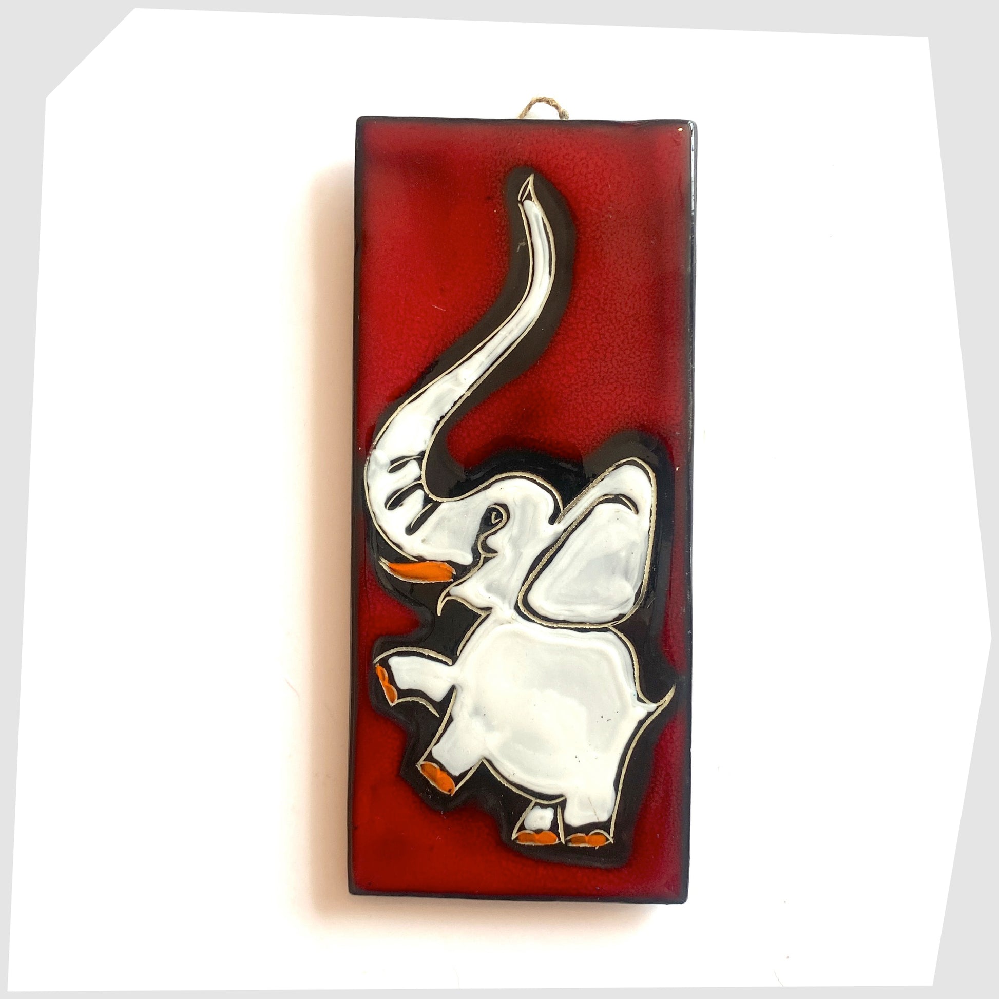 Rectangular San Marino Pottery Wall Plaque featuring a white elephant with pops of orange on a vivid red glaze, shown on a white background