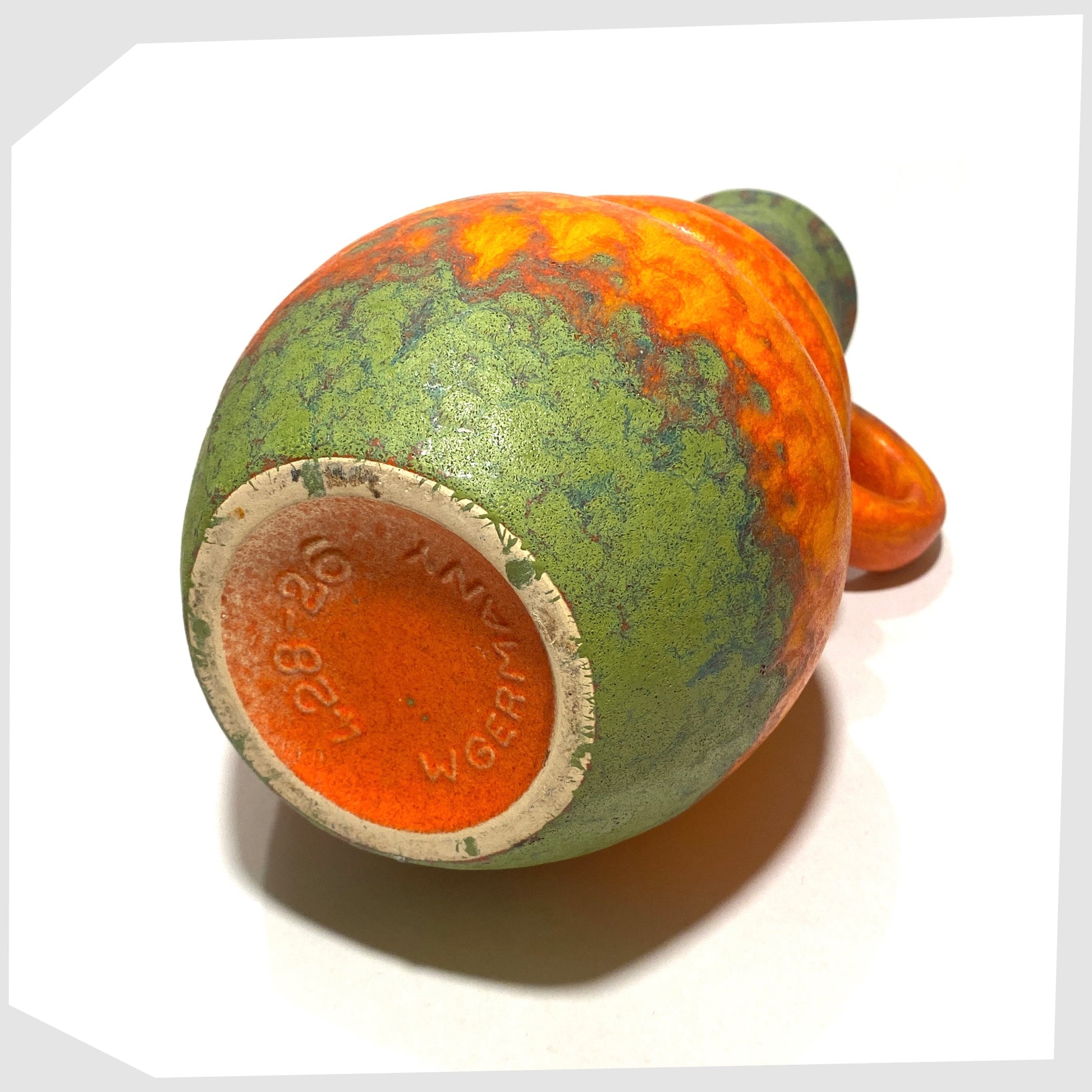base of the scheurich keramik 428-26 vase finished in a volcanic orange glaze with vivid matte green