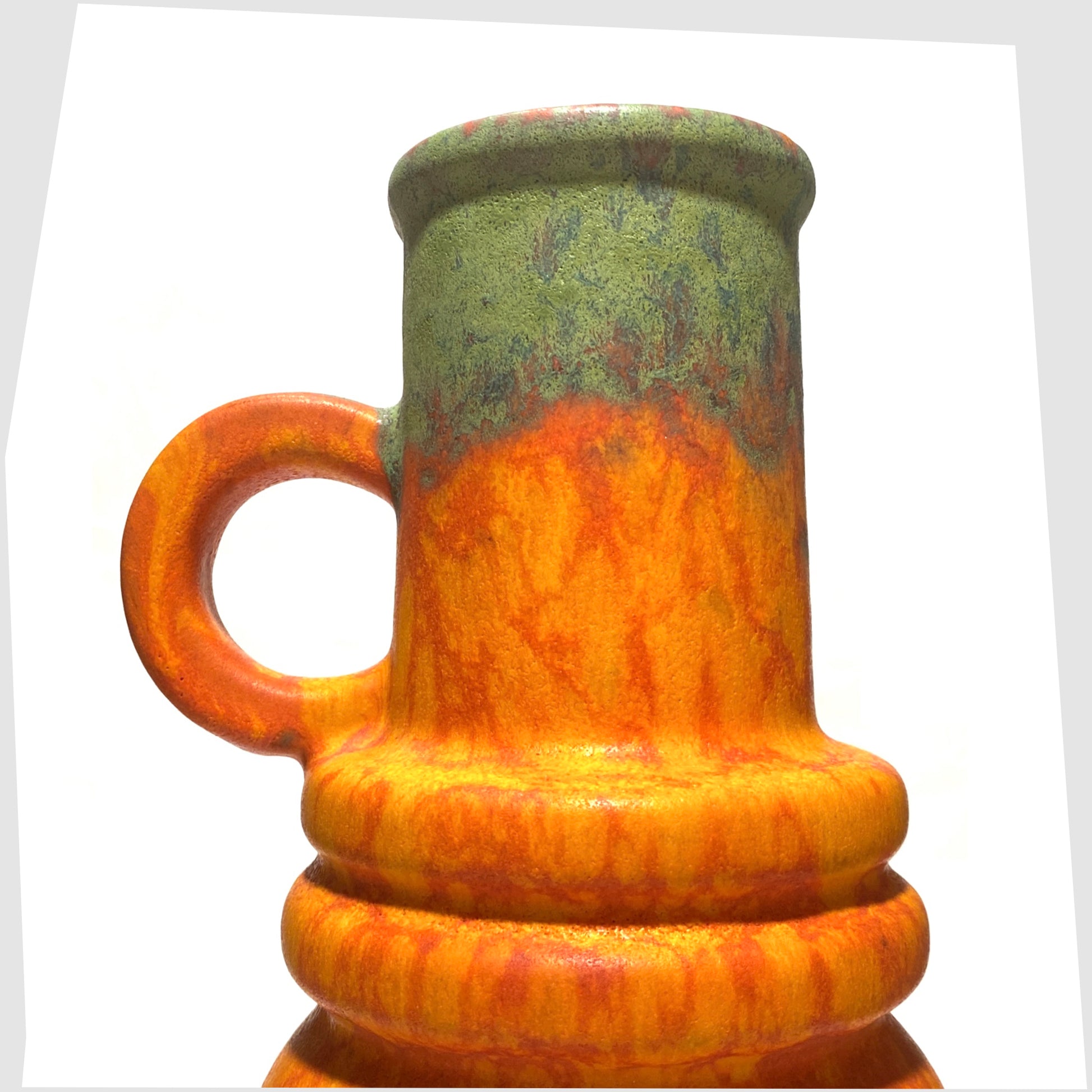 top neck of the scheurich keramik 428-26 vase finished in a volcanic orange glaze with vivid matte green