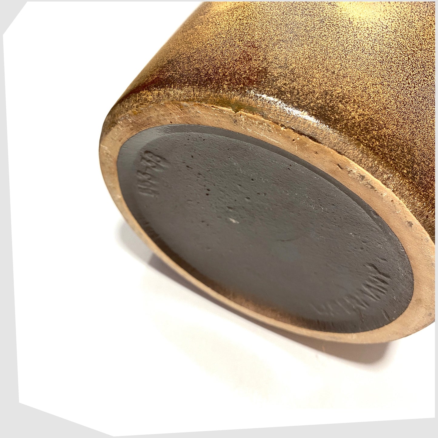 base rim of the scheurich keramik floor vase, model 553-38, glazed with a bold band of forest  green with amber circles