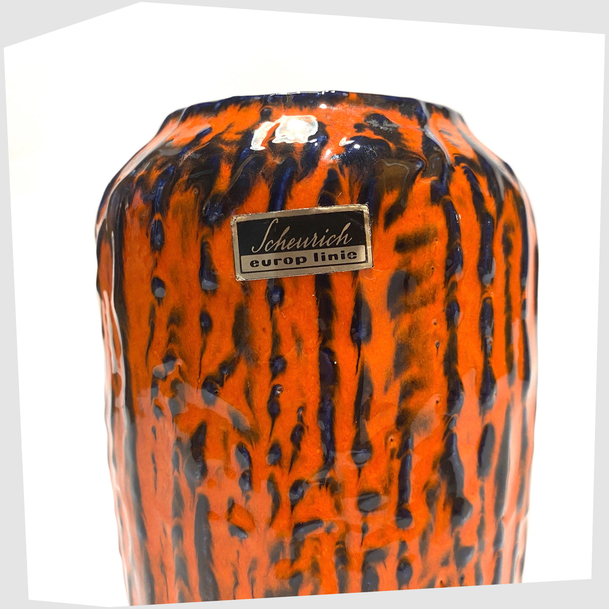 Close up of the original label on the Scheurich Keramik 238-14 Vase, part of Scheurich's 'Europ Linie' collection, in a vivid orange and blue fat lava glaze, shown on a white background