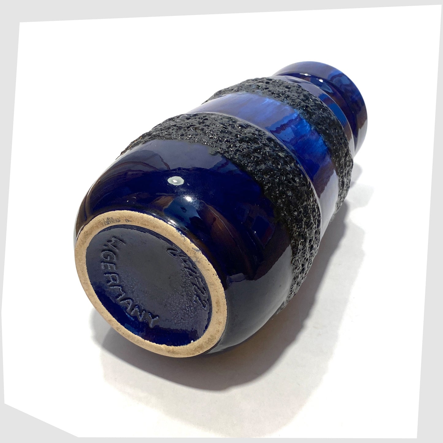 base of the Scheurich Keramik 242-22 Vase in a rich blue glaze with bands of black fat lava