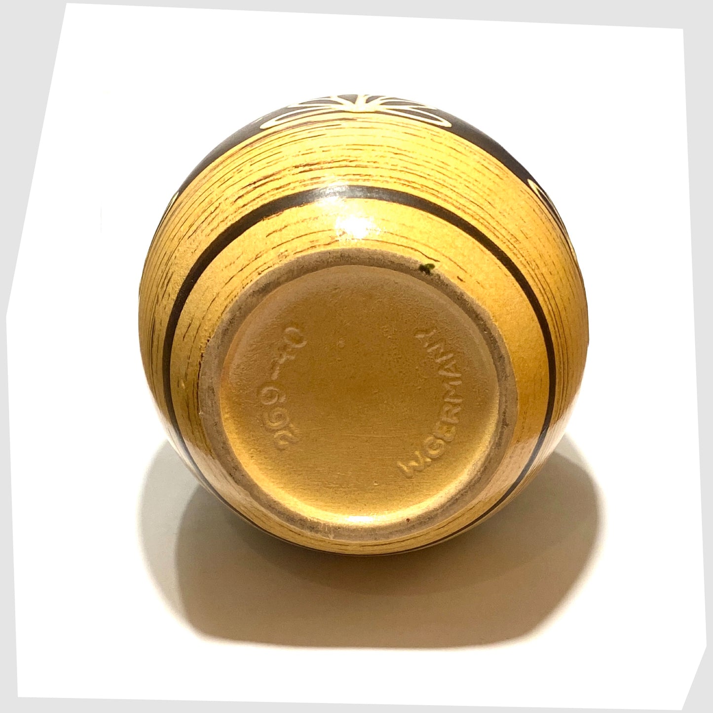 base of the west german pottery floor vase by scheurich keramik model-269-40 in a yellow/beige and brown glaze with floral design