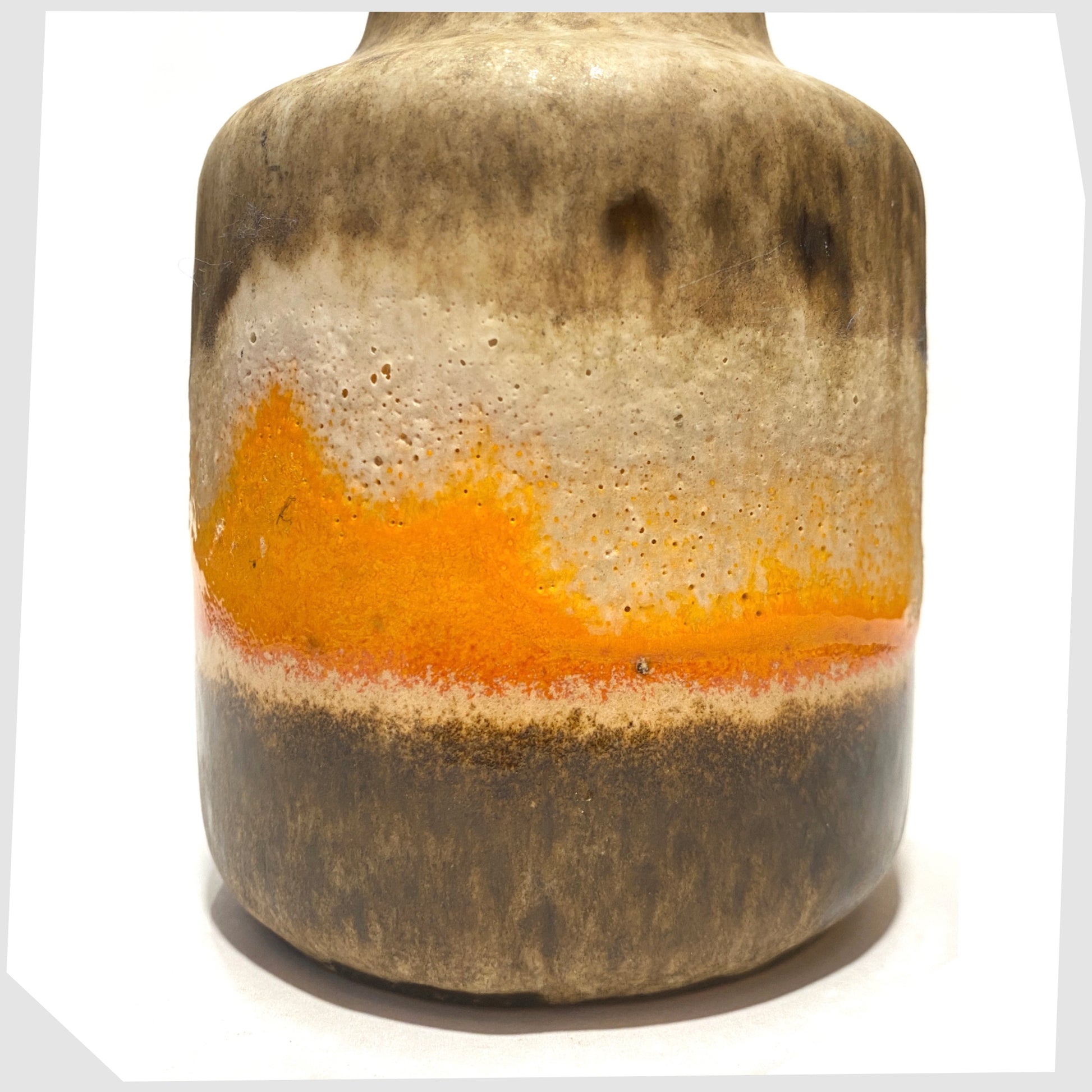 Close up of the Scheurich Keramik 414-16 Vase in matte fat lava drip glaze with contrasting band of vibrant orange gloss glaze, shown on a white background