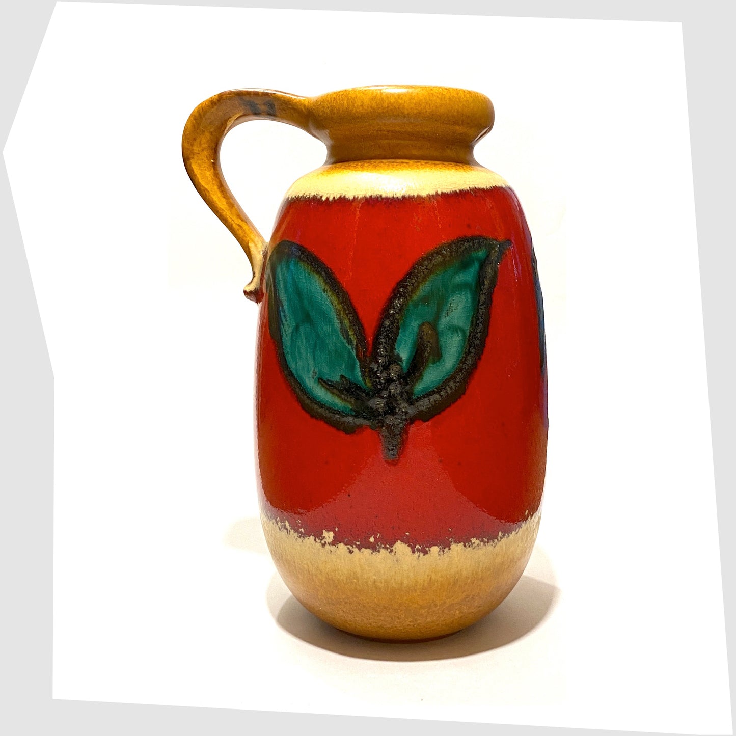 rear of the scheurich keramik 484-27 vase with handle, glazed with green leaves on a red background