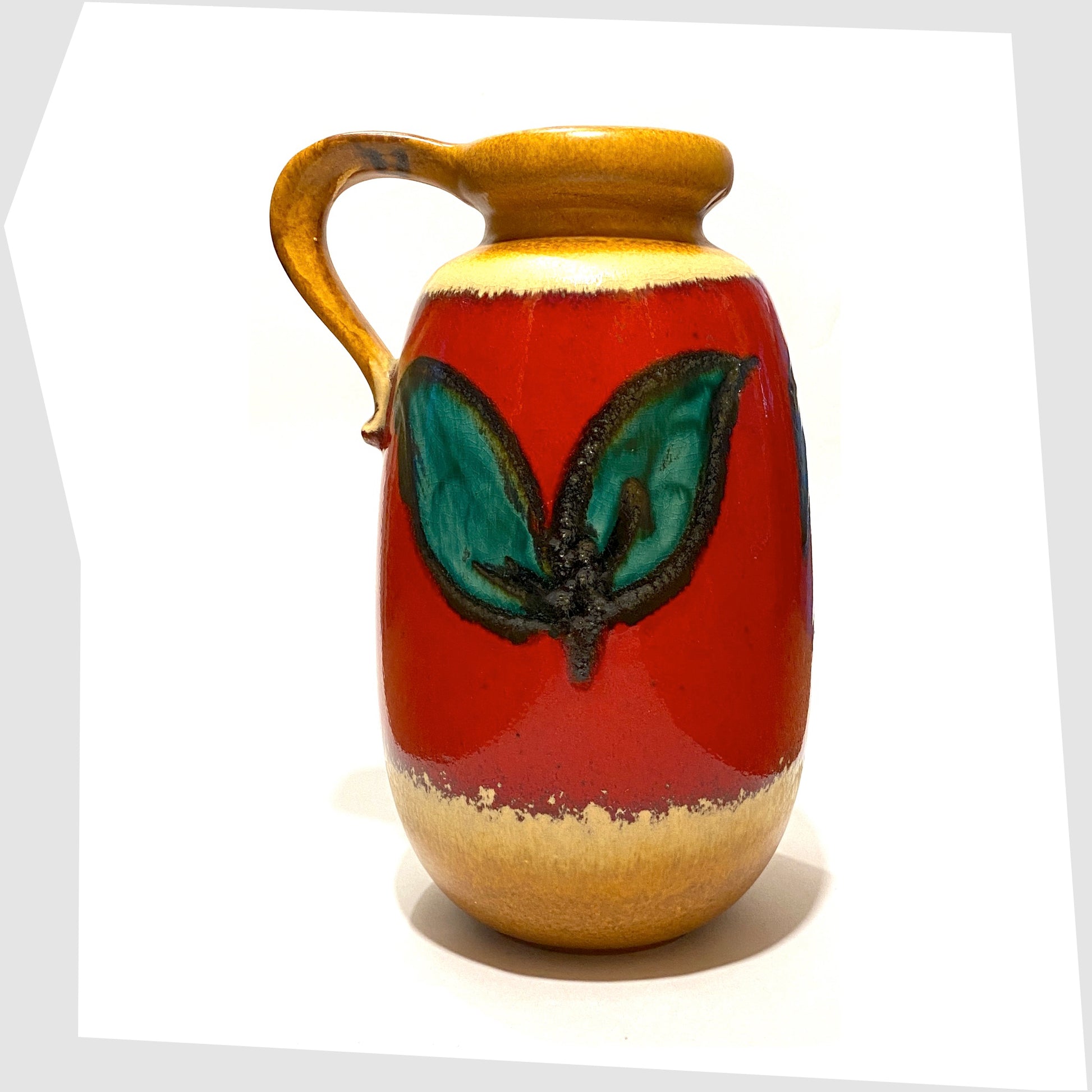 rear of the scheurich keramik 484-27 vase with handle, glazed with green leaves on a red background