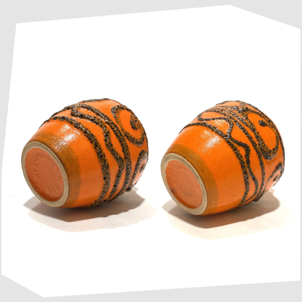 Base of the Pair of Scheurich Keramik 550-10 Vases in orange glaze with swirls of deep fat lava, shown on a white background