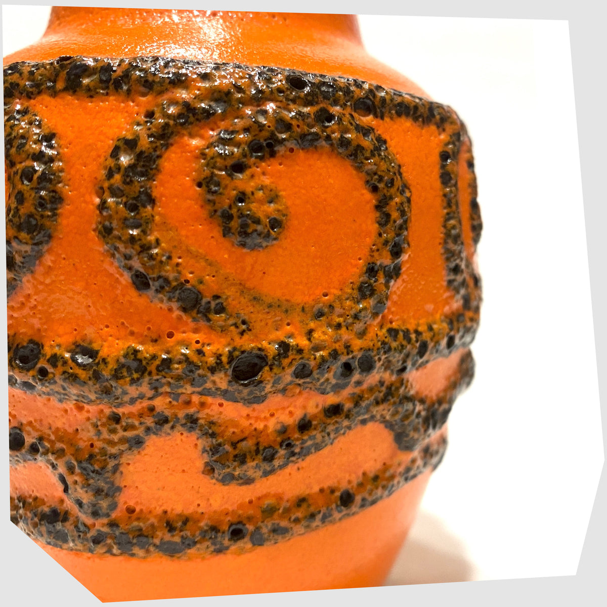Close up of the Scheurich Keramik 550-10 Vase in orange glaze with swirls of deep fat lava, shown on a white background