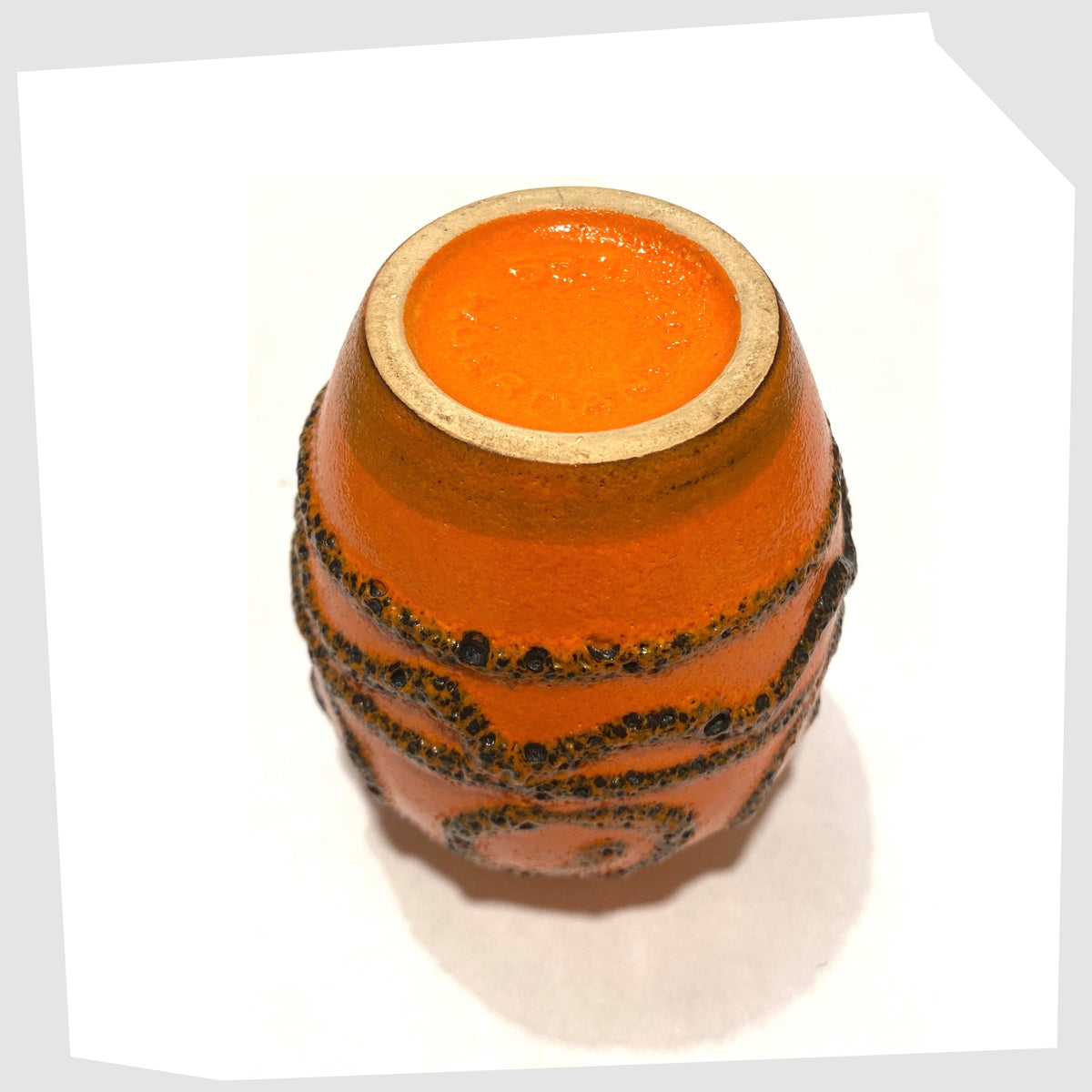 Underneath of the Scheurich Keramik 550-10 Vase in vibrant orange glaze with deep fat lava swirls and flowing lines, shown on a white background