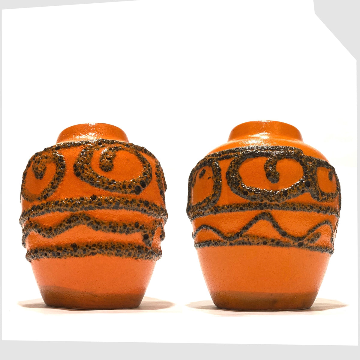 Pair of West German Pottery Scheurich Keramik 550-10 Vases in orange glaze with swirls of deep fat lava, shown on a white background