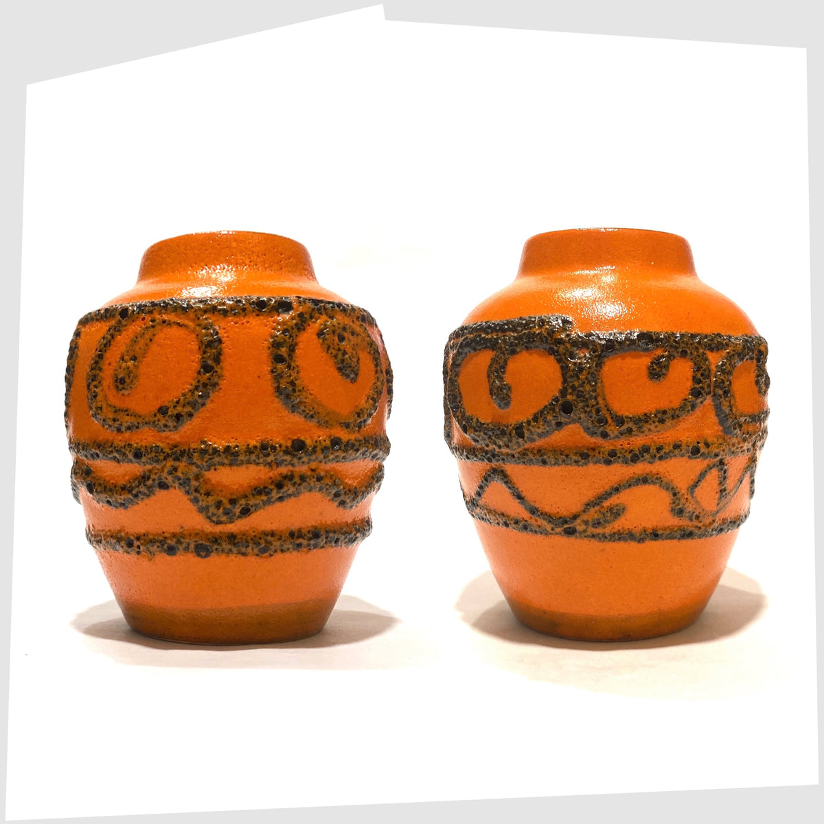 Pair of Scheurich Keramik 550-10 Vases in orange glaze with swirls of deep fat lava, shown on a white background