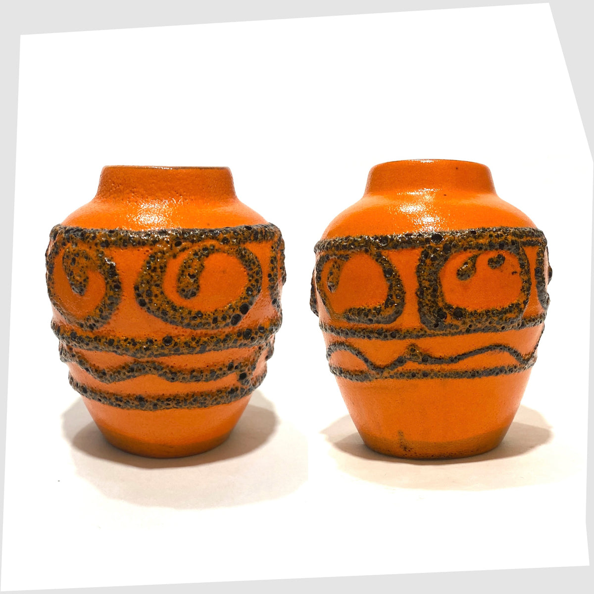 Pair of 1970s Scheurich Keramik 550-10 Vases in orange glaze with swirls of deep fat lava, shown on a white background