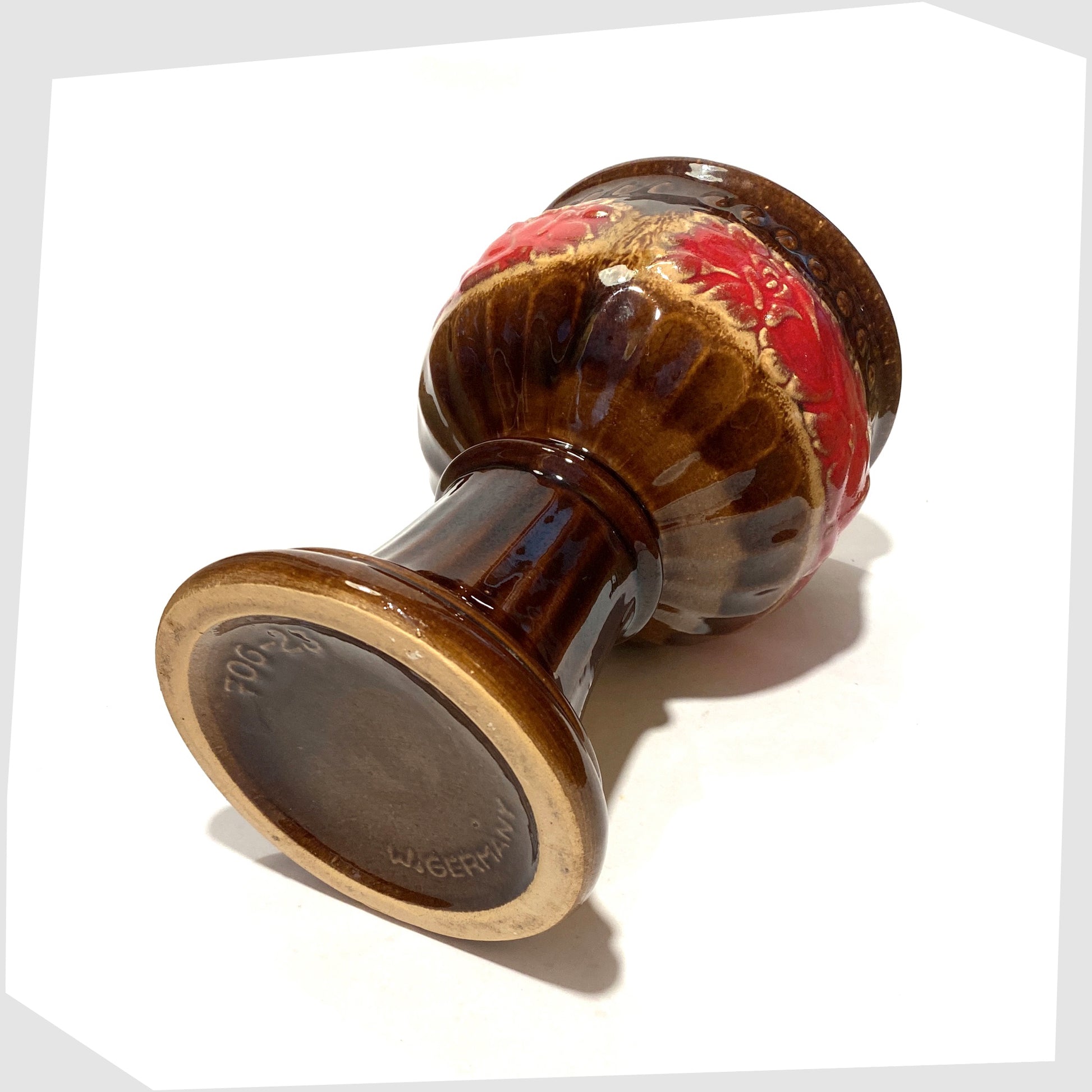 base of the schuerich keramik 706-23 footed planter in chestnut glaze with central band of volcanic red glaze