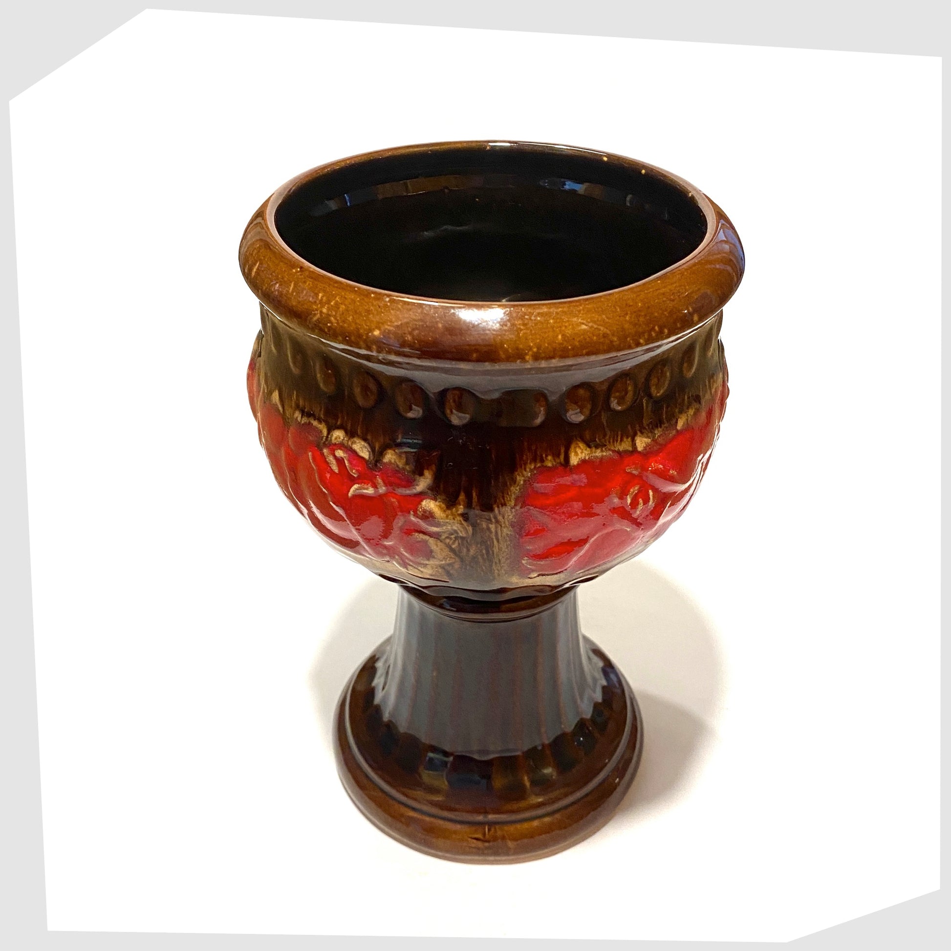 top rim of the schuerich keramik 706-23 footed planter in chestnut glaze with central band of volcanic red glaze