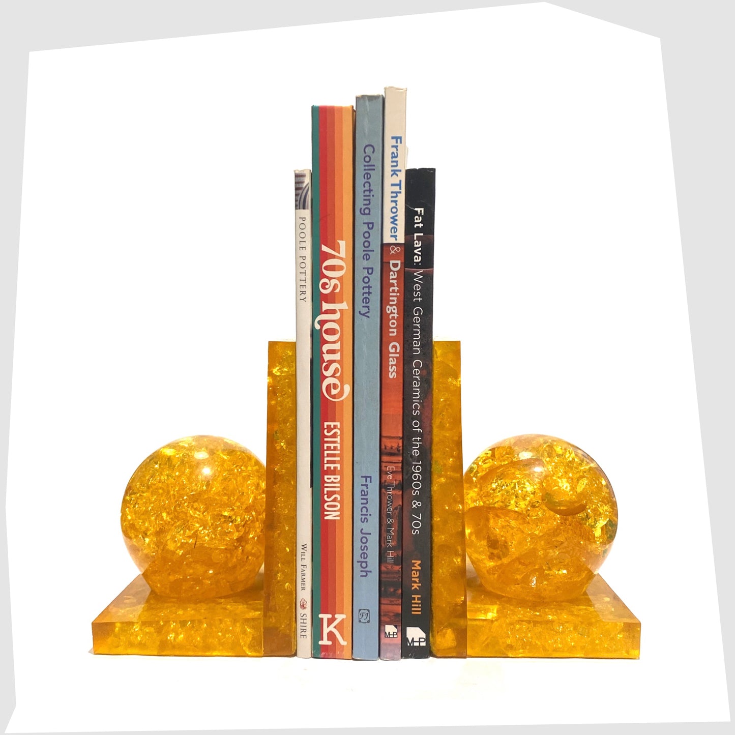 mid-century modern Shattaline Bookend in orange resin shown with a selection of books inside