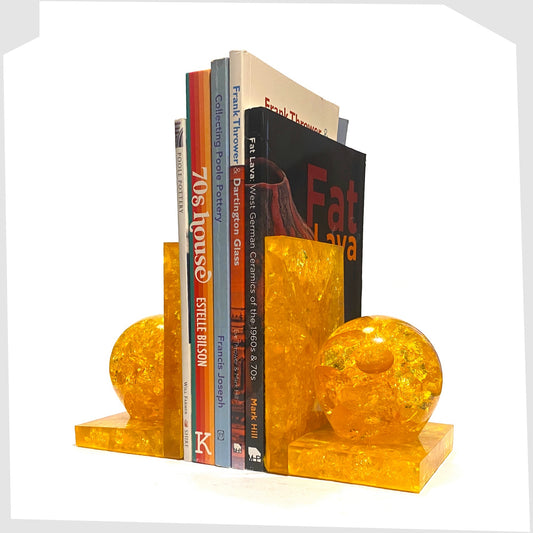 Pair of vintage Shattaline Bookends in orange fractal resin, shown with a selection of books