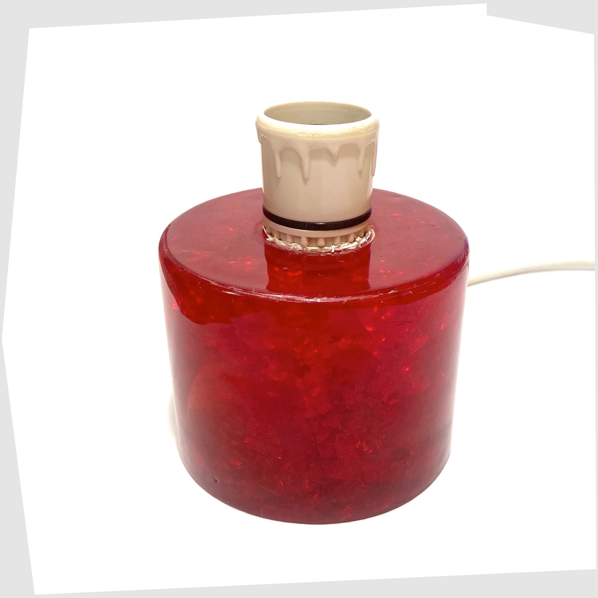 A Red Shattaline Table Lamp with white bulb holder and electrical flex.