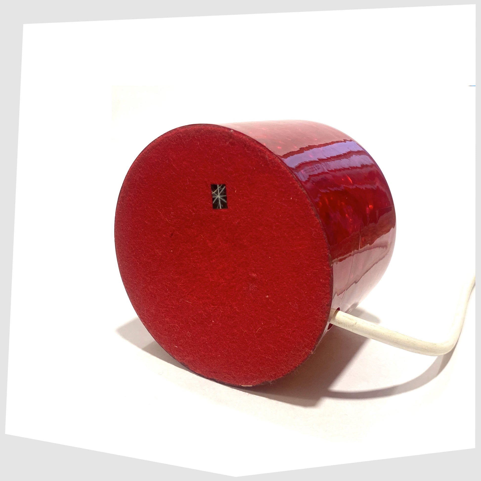Base of the r ed Shattaline Table Lamp with a red felted base, with original black retail sticker