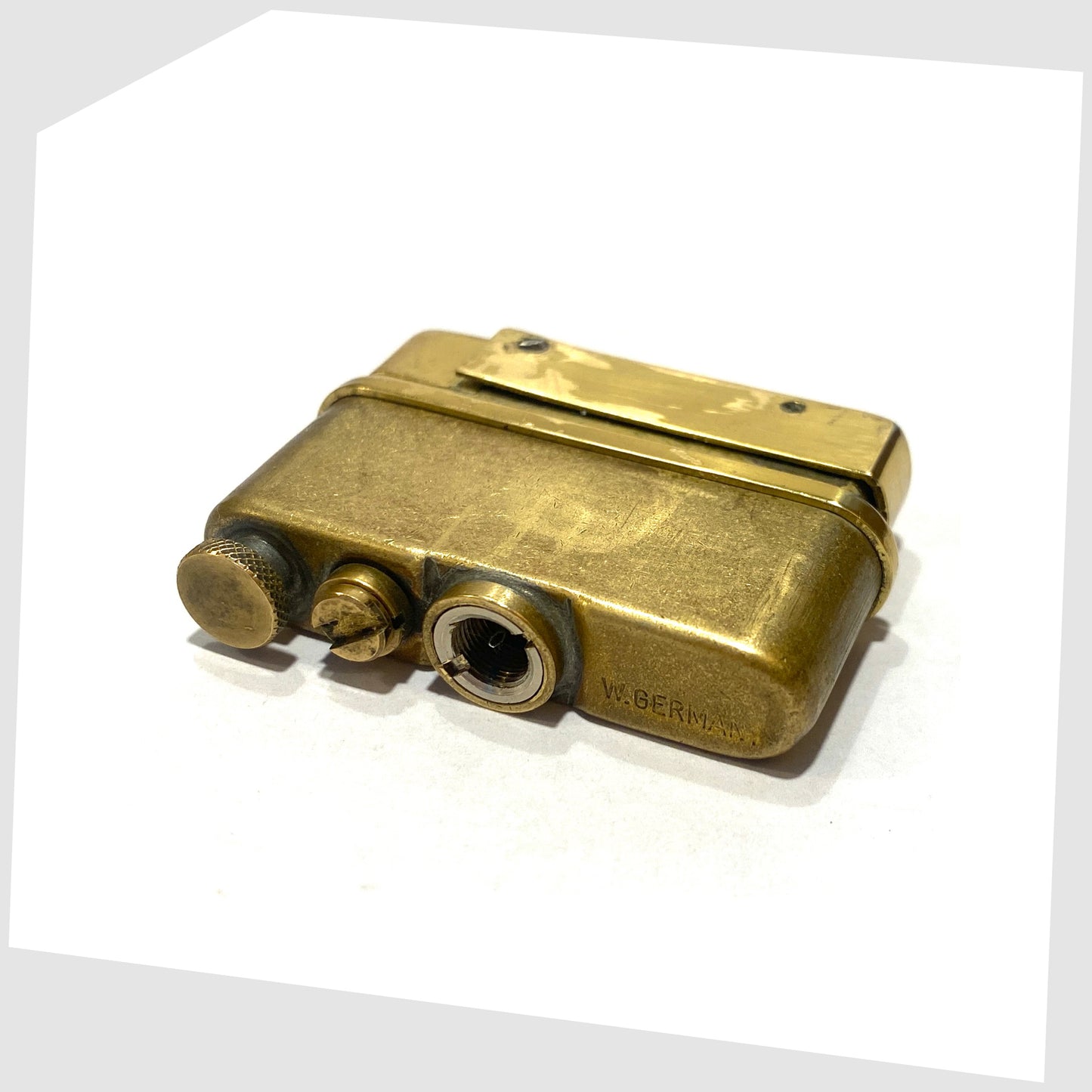 Orange Shattaine Table Lighter's brass lighter fitting, shown with engraved W. Germany marking