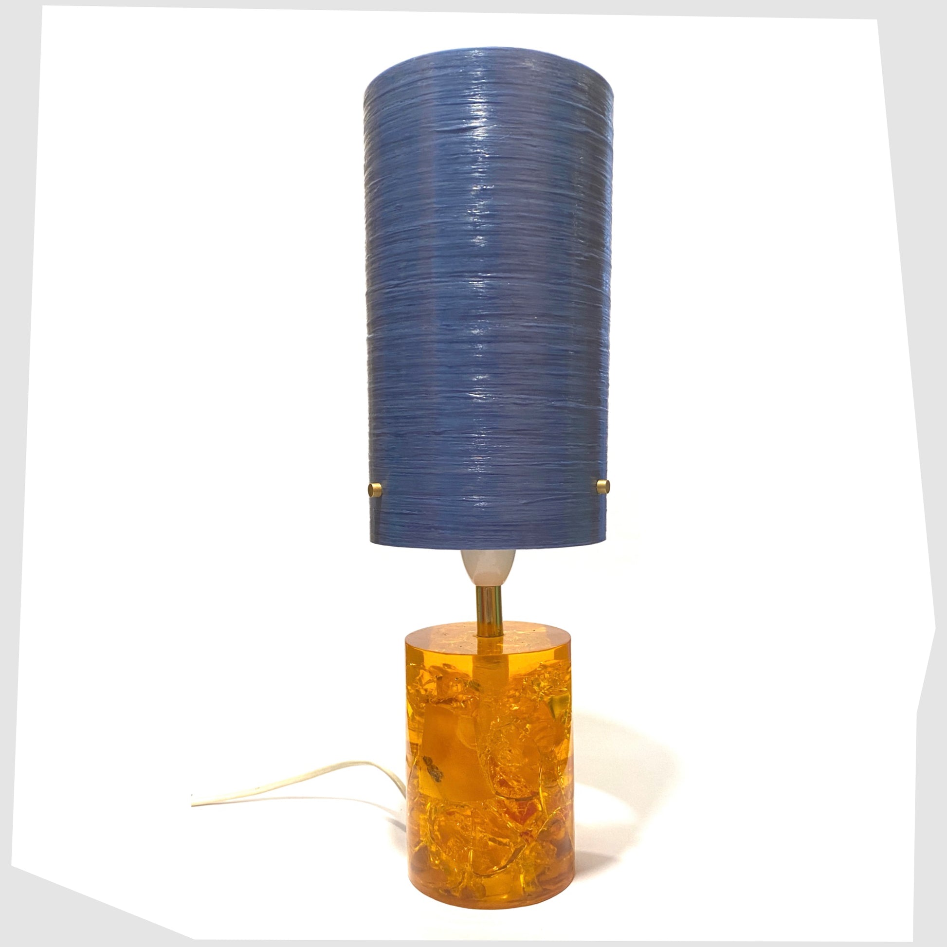 Blue Royplast Spun Fibreglass Lampshade by By Royale shown on an orange Shattaline table lamp base