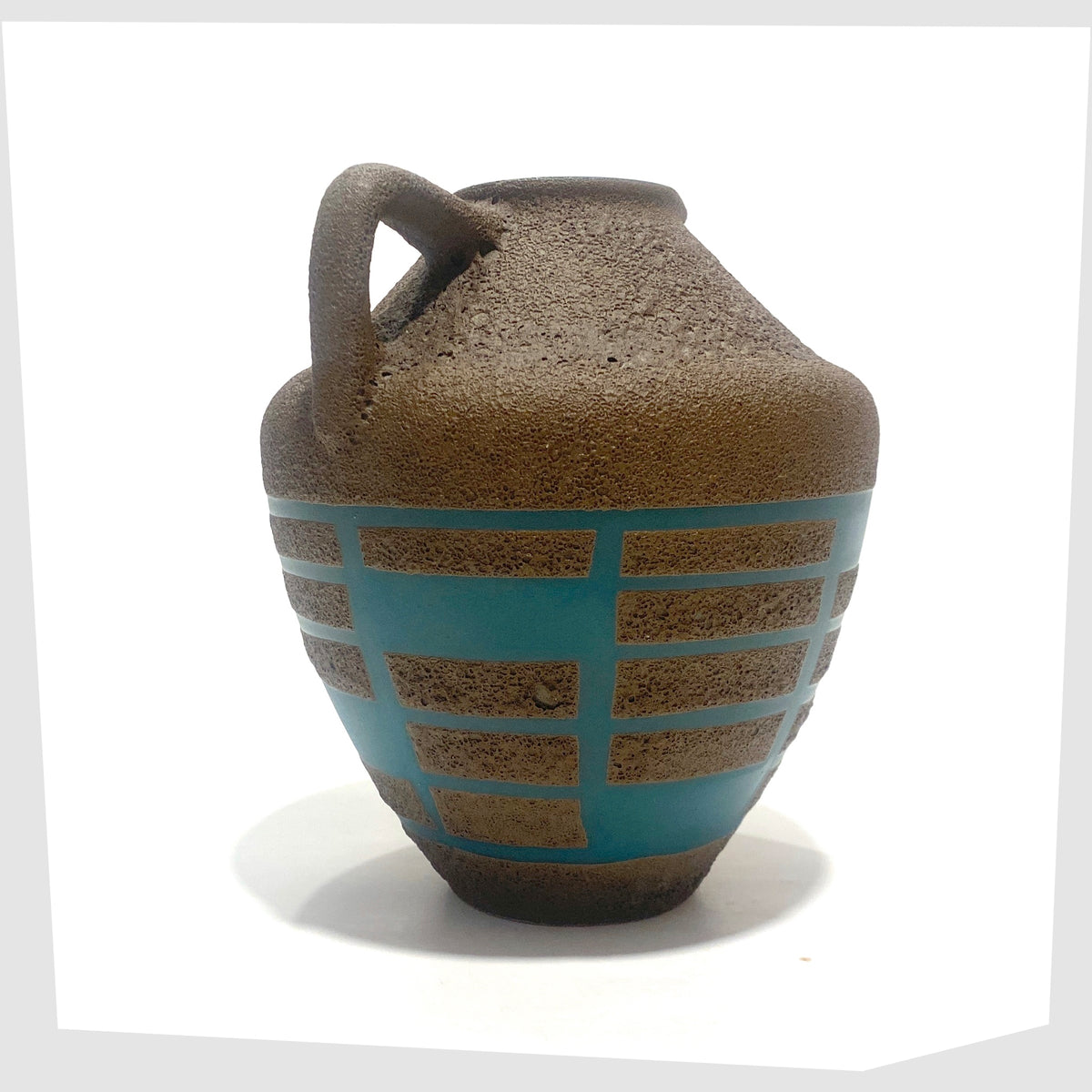 Handle of the Steuler Keramik 4321/00 Vase in teal glaze with matte fat lava geometric shapes, shown on a white background