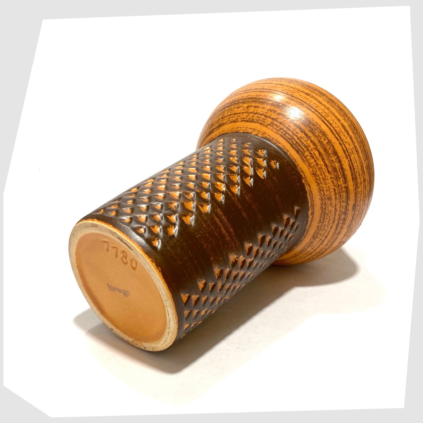Base of the Strehla Keramik 1180 Vase with architectural mushroom form in burnt orange glaze with artistic geometric pattern, shown on a white background