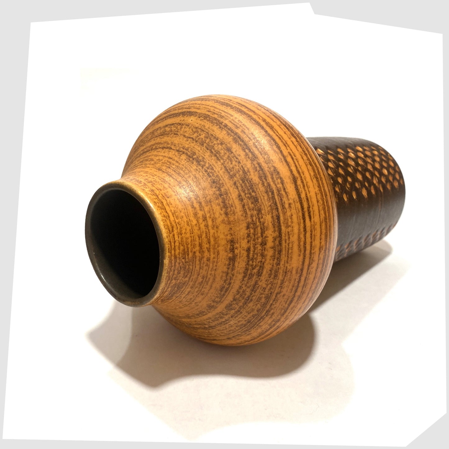 Top rim of the Strehla Keramik 1180 Vase with architectural mushroom form in burnt orange glaze with artistic geometric pattern, shown on a white background