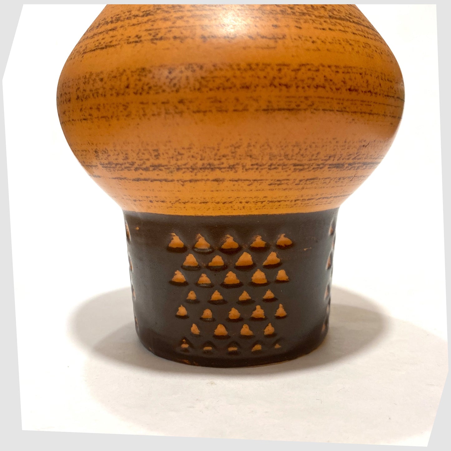 Close up of the Strehla Keramik 1182 Vase with a bold architectural form in burnt range and chestnut brown glaze, shown on a white background