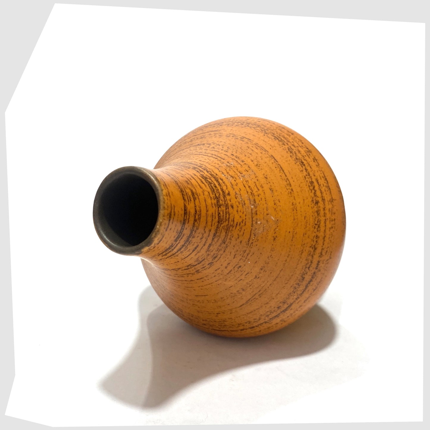 Top rim and inner glaze of the Strehla Keramik 1182 Vase with a bold architectural form in burnt range and chestnut brown glaze, shown on a white background